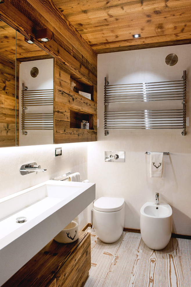 Design ideas for a medium sized rustic shower room bathroom in Turin with flat-panel cabinets, dark wood cabinets, white walls, light hardwood flooring, a trough sink, wooden worktops, porcelain tiles, an alcove shower, a one-piece toilet and white tiles.