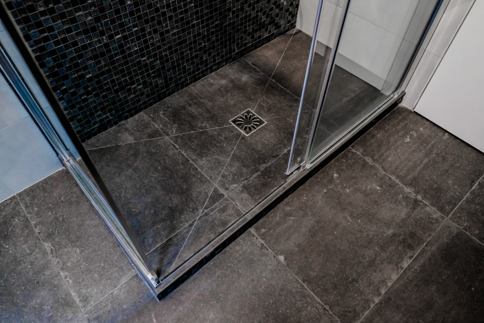 Design ideas for a small contemporary shower room bathroom in Other with a corner shower, a two-piece toilet, white tiles, porcelain tiles, white walls, porcelain flooring, a console sink, solid surface worktops, grey floors, a sliding door and white worktops.