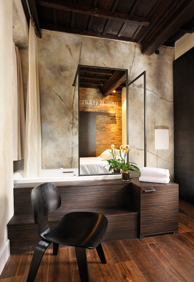 Inspiration for a mid-sized industrial 3/4 medium tone wood floor bathroom remodel in Rome with a two-piece toilet, gray walls and a trough sink