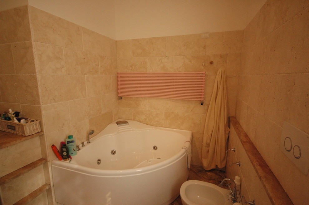 Inspiration för mellanstora moderna badrum med dusch, med öppna hyllor, beige skåp, en jacuzzi, våtrum, en toalettstol med separat cisternkåpa, beige kakel, travertinkakel, beige väggar, travertin golv, ett fristående handfat, bänkskiva i kalksten, rött golv och med dusch som är öppen