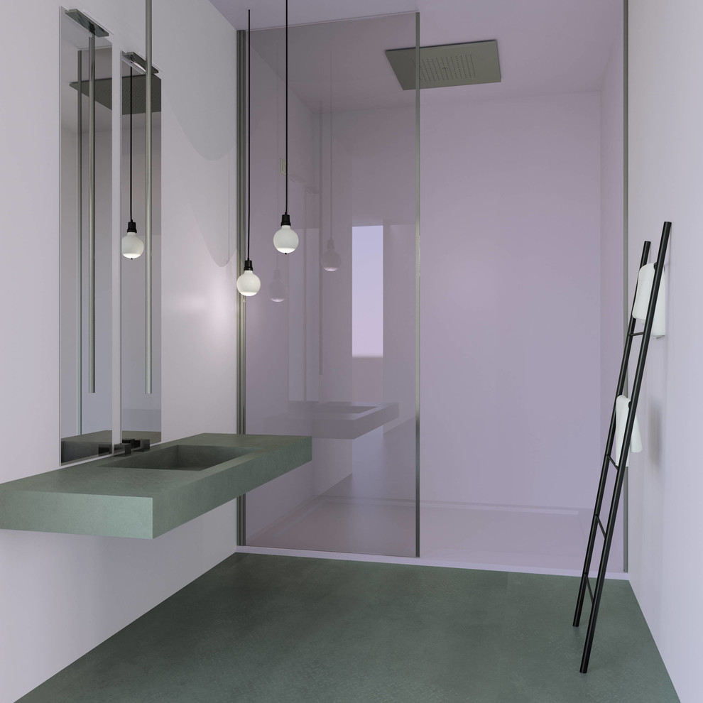 Modelo de cuarto de baño minimalista con paredes rosas, suelo de cemento, aseo y ducha, encimera de cemento y suelo gris