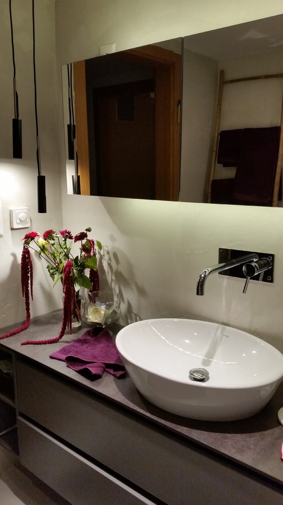 Idee per una stanza da bagno padronale design di medie dimensioni con consolle stile comò, vasca freestanding, WC sospeso, pareti multicolore e lavabo a bacinella