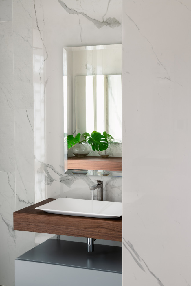 Inspiration for a large contemporary ensuite bathroom in Rome with flat-panel cabinets, grey cabinets, a corner shower, a wall mounted toilet, porcelain tiles, white walls, porcelain flooring, a vessel sink, wooden worktops, a hinged door, a wall niche, double sinks, a floating vanity unit and a drop ceiling.