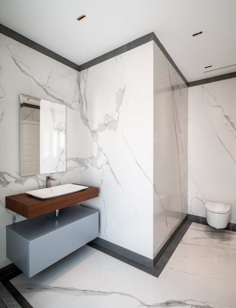 Large trendy master porcelain tile porcelain tile, double-sink and tray ceiling corner shower photo in Rome with flat-panel cabinets, gray cabinets, a wall-mount toilet, white walls, a vessel sink, wood countertops, a hinged shower door, a niche and a floating vanity