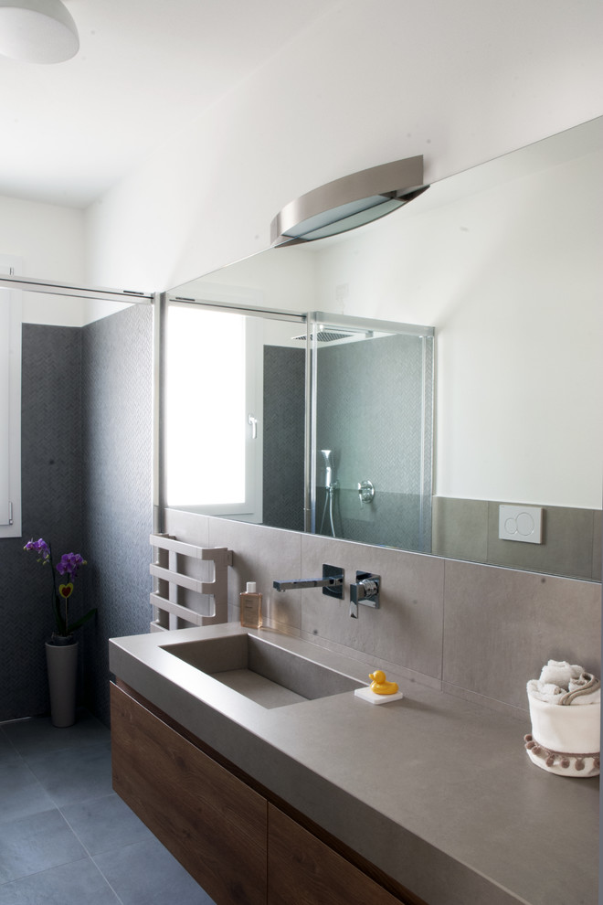 This is an example of a medium sized contemporary shower room bathroom in Other with a built-in shower, a two-piece toilet, brown tiles, porcelain tiles, brown walls, porcelain flooring, an integrated sink, grey floors, a sliding door and brown worktops.