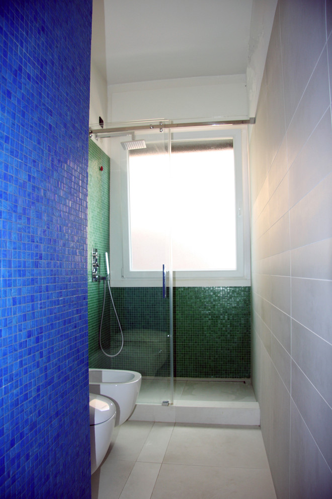 Exempel på ett mellanstort modernt en-suite badrum, med en kantlös dusch, en vägghängd toalettstol, blå kakel, mosaik, blå väggar, klinkergolv i keramik, ett fristående handfat och kaklad bänkskiva