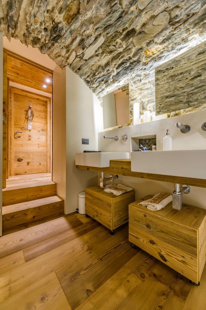 Immagine di una stanza da bagno padronale stile rurale di medie dimensioni con ante lisce, ante in legno scuro, pareti bianche, pavimento in legno massello medio e top in legno