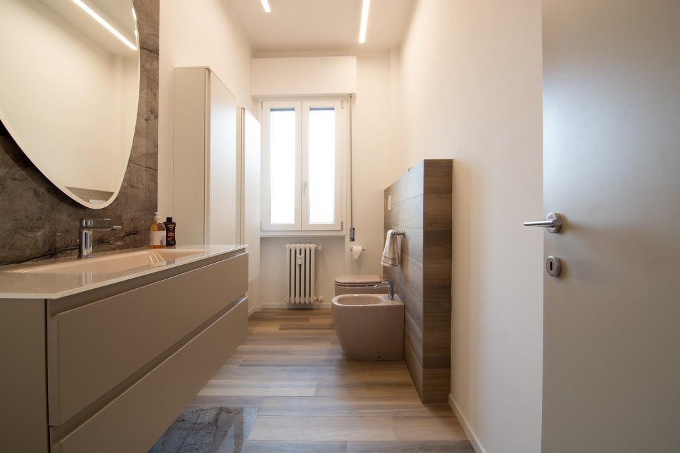 Photo of a medium sized contemporary bathroom in Florence with flat-panel cabinets, beige cabinets, a two-piece toilet, brown tiles, porcelain tiles, white walls, porcelain flooring, an integrated sink, glass worktops, beige floors, beige worktops, a single sink and a floating vanity unit.