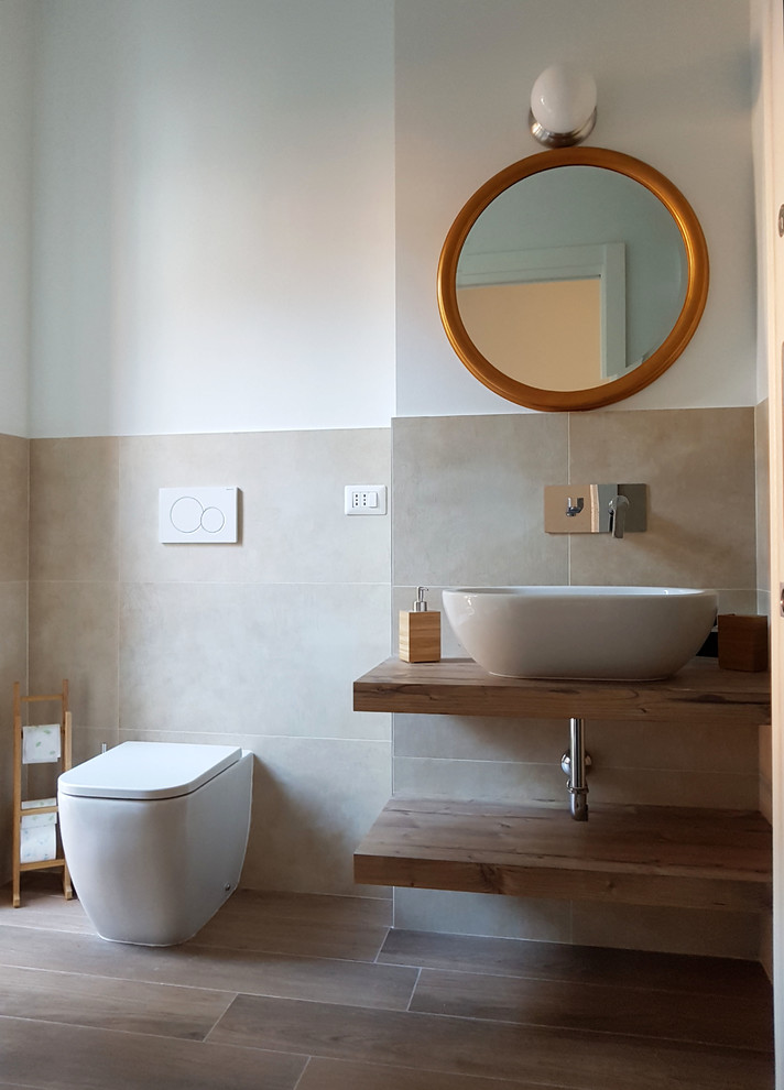 Design ideas for a medium sized contemporary ensuite bathroom in Milan with light wood cabinets, a built-in shower, a two-piece toilet, beige tiles, porcelain tiles, white walls, porcelain flooring, a vessel sink, laminate worktops, brown floors, a hinged door and beige worktops.