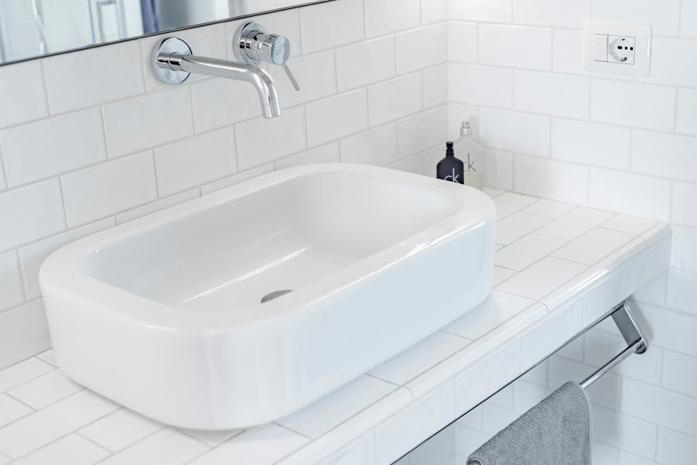 Example of a small danish 3/4 white tile and ceramic tile porcelain tile, gray floor and single-sink bathroom design in Rome with a two-piece toilet, gray walls, a vessel sink, tile countertops and white countertops