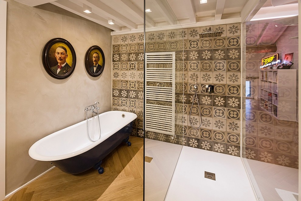 Diseño de cuarto de baño principal ecléctico con bañera con patas, ducha abierta, baldosas y/o azulejos de cerámica, paredes grises, suelo de madera clara y ducha abierta