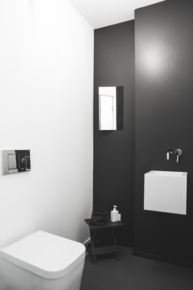 Idee per un piccolo bagno di servizio minimal con WC monopezzo, pareti grigie, lavabo rettangolare e pavimento grigio