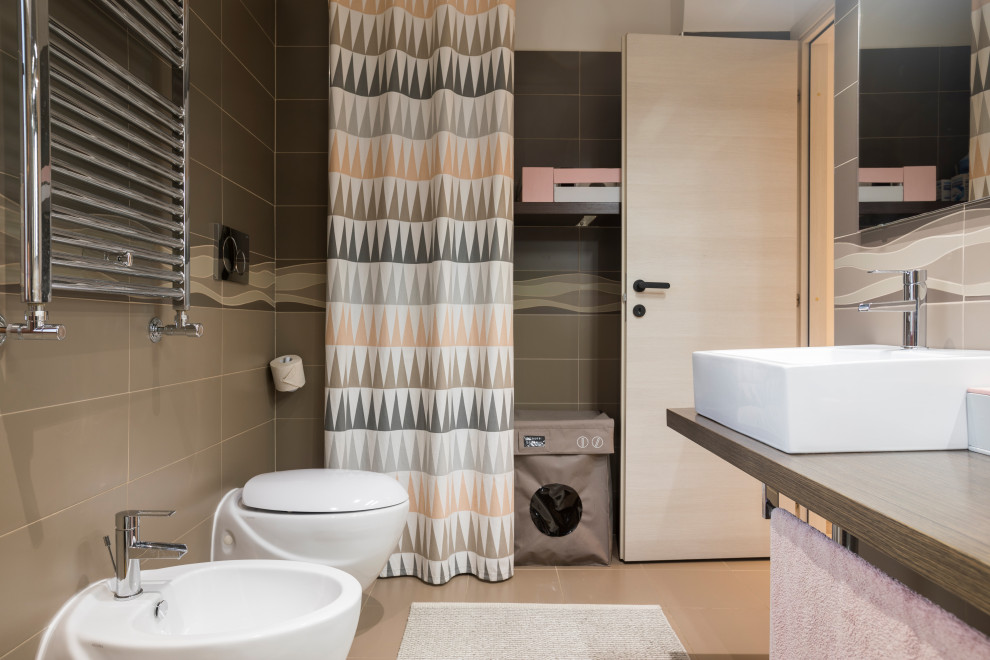 Design ideas for a medium sized contemporary shower room bathroom in Rome with a wall mounted toilet, porcelain flooring, a vessel sink, wooden worktops, beige floors, double sinks, a floating vanity unit, medium wood cabinets, brown tiles, porcelain tiles, brown walls, brown worktops and a laundry area.