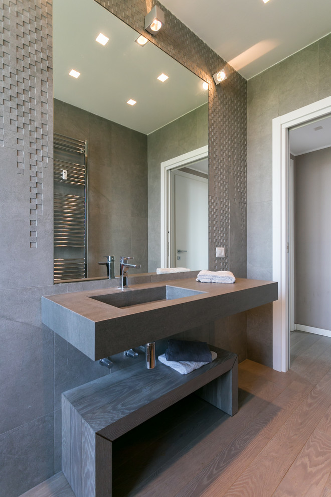 Alcove shower - mid-sized contemporary master gray tile alcove shower idea in Milan with open cabinets, a one-piece toilet, gray walls, an integrated sink and a hinged shower door