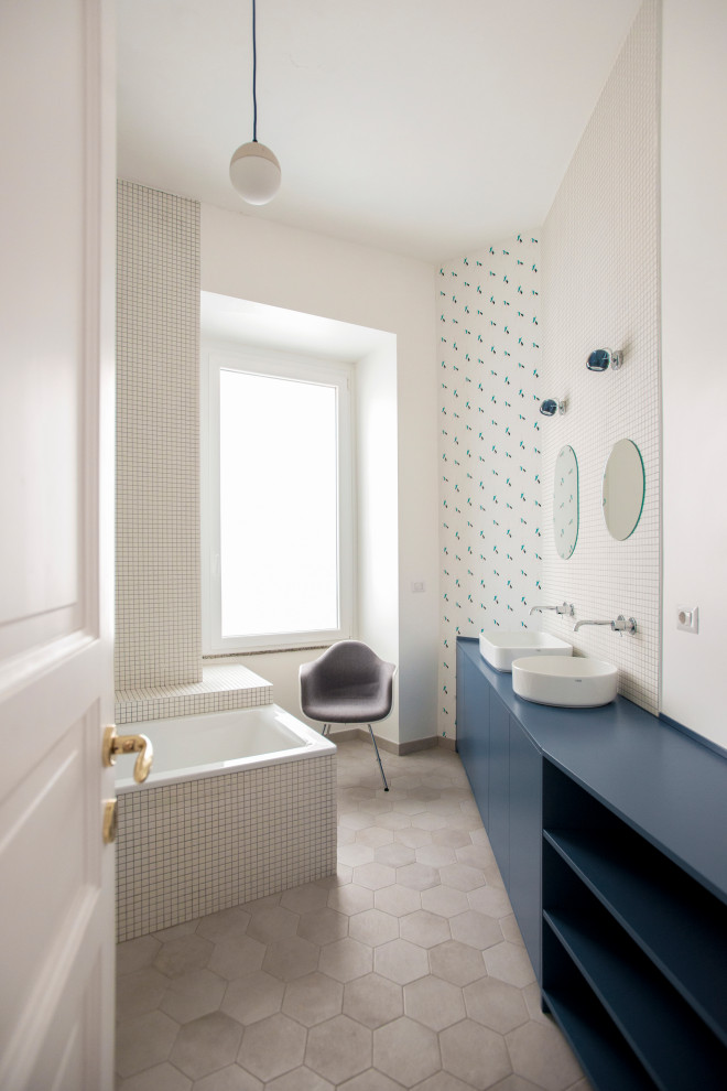 Medium sized contemporary ensuite bathroom in Rome with flat-panel cabinets, blue cabinets, a built-in bath, white tiles, porcelain tiles, white walls, porcelain flooring, a vessel sink, beige floors, blue worktops, double sinks and a built in vanity unit.