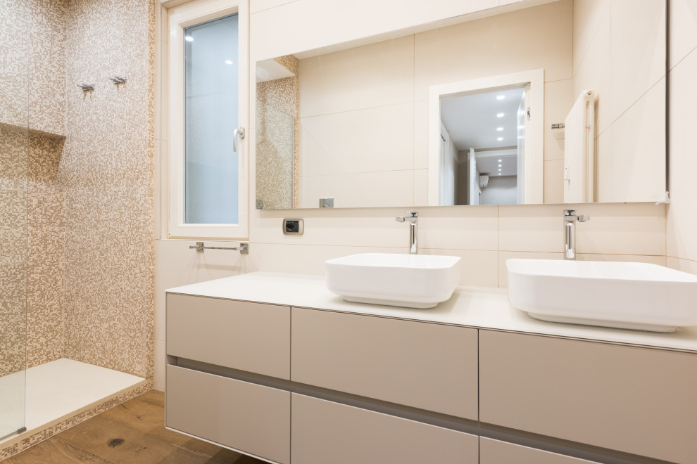 Medium sized contemporary shower room bathroom in Rome with glass-front cabinets, a walk-in shower, beige tiles, porcelain tiles, beige walls, dark hardwood flooring, a vessel sink, glass worktops, white worktops, double sinks, a floating vanity unit, beige cabinets and an open shower.