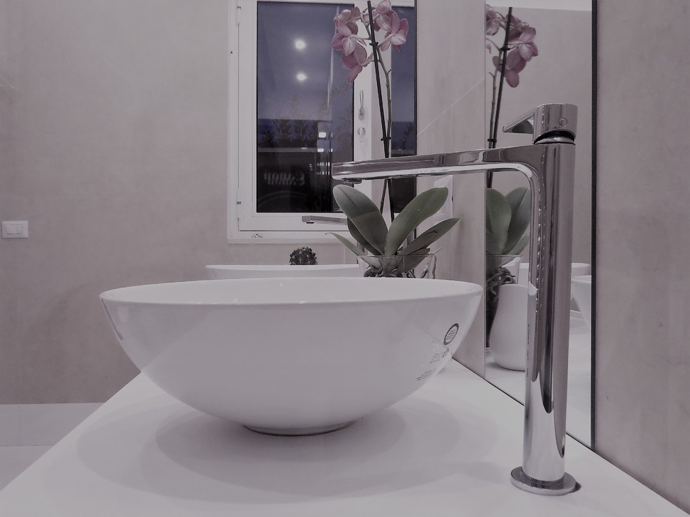 Design ideas for a small contemporary ensuite bathroom in Naples with open cabinets, light wood cabinets, a built-in bath, a wall mounted toilet, pink tiles, porcelain tiles, white walls, ceramic flooring, a vessel sink, wooden worktops and black floors.
