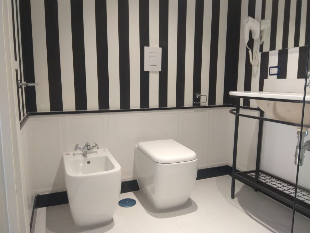 Inspiration for a medium sized contemporary shower room bathroom in Naples with open cabinets, black cabinets, an alcove shower, a two-piece toilet, black and white tiles, porcelain tiles, white walls, porcelain flooring, an integrated sink, quartz worktops, white floors, black worktops, a single sink, a freestanding vanity unit and wallpapered walls.