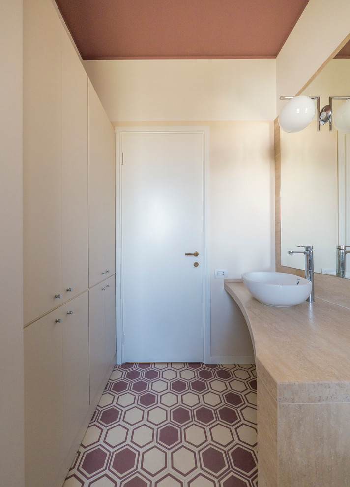 Example of a mid-sized minimalist master multicolored tile and porcelain tile bathroom design in Milan with flat-panel cabinets, beige cabinets, a two-piece toilet, beige walls, a vessel sink and marble countertops