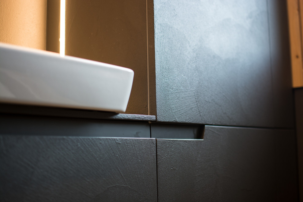 Foto på ett mellanstort industriellt grå badrum med dusch, med släta luckor, grå skåp och bänkskiva i betong
