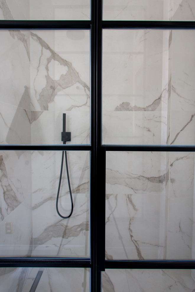 Inspiration for a small scandinavian 3/4 white tile and marble tile marble floor and gray floor alcove shower remodel with glass-front cabinets, black cabinets, a two-piece toilet, white walls, a trough sink, marble countertops and a hinged shower door