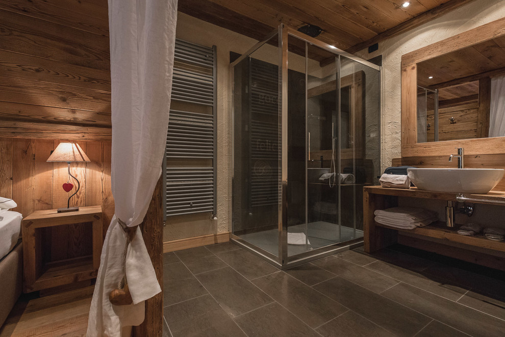 Large rustic ensuite bathroom in Other with open cabinets, a corner shower, medium hardwood flooring, a vessel sink and a sliding door.