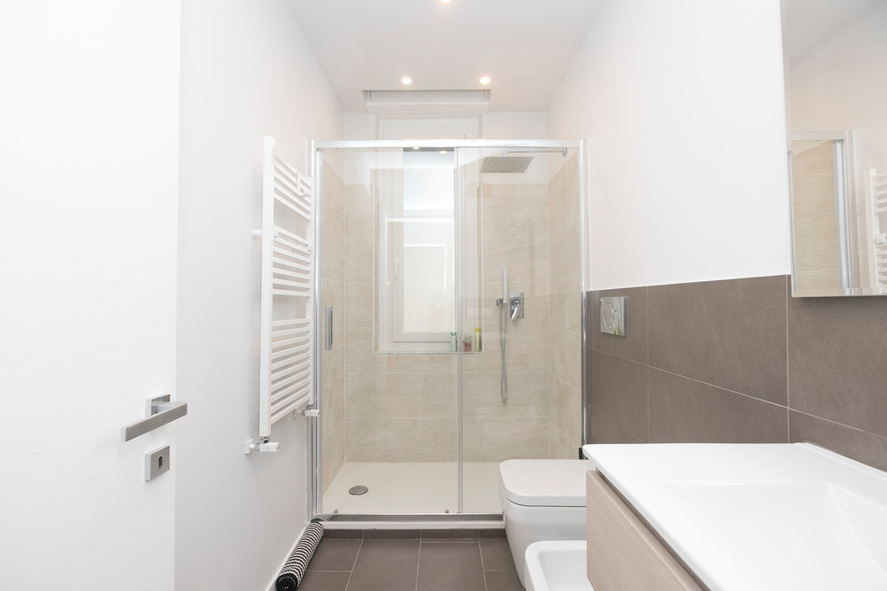 Photo of a medium sized contemporary shower room bathroom in Other with freestanding cabinets, beige cabinets, a walk-in shower, brown tiles, porcelain tiles, white walls, porcelain flooring, a built-in sink, solid surface worktops, brown floors and a sliding door.