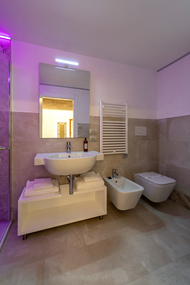 Medium sized contemporary shower room bathroom in Venice with open cabinets, white cabinets, a built-in shower, a two-piece toilet, beige tiles, porcelain tiles, white walls, porcelain flooring, a wall-mounted sink, beige floors and a sliding door.
