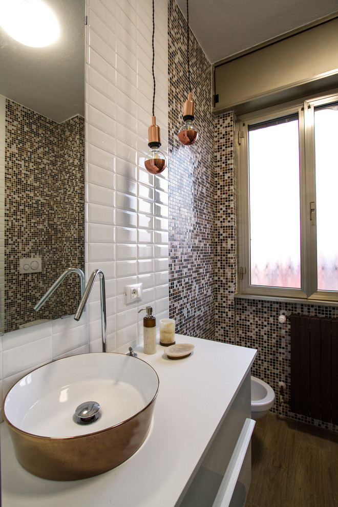 Idee per una piccola stanza da bagno con doccia design con ante lisce, ante bianche, WC sospeso, piastrelle marroni, piastrelle a mosaico, pavimento con piastrelle in ceramica, lavabo a bacinella, pavimento marrone e top bianco