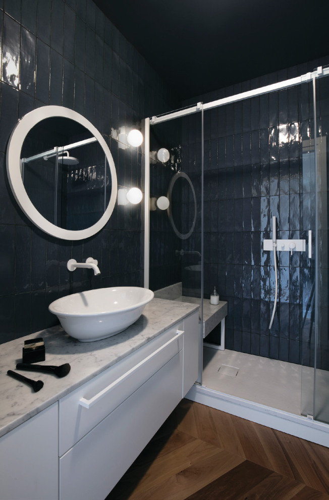 This is an example of a large contemporary shower room bathroom in Other with flat-panel cabinets, white cabinets, black tiles, a vessel sink, brown floors, grey worktops, a shower bench, a single sink and a floating vanity unit.