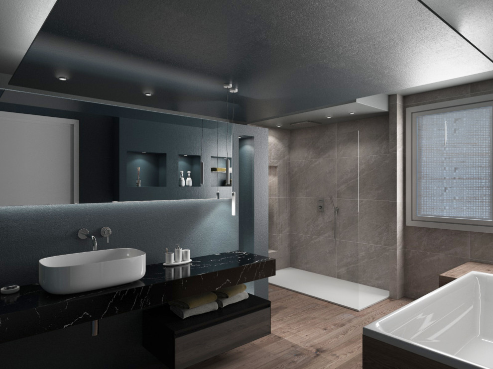 This is an example of an expansive contemporary ensuite bathroom in Venice with flat-panel cabinets, medium wood cabinets, a freestanding bath, a walk-in shower, a two-piece toilet, grey tiles, porcelain tiles, blue walls, wood-effect flooring, a vessel sink, marble worktops, beige floors, an open shower, black worktops, a wall niche, a single sink, a floating vanity unit, a drop ceiling and wallpapered walls.