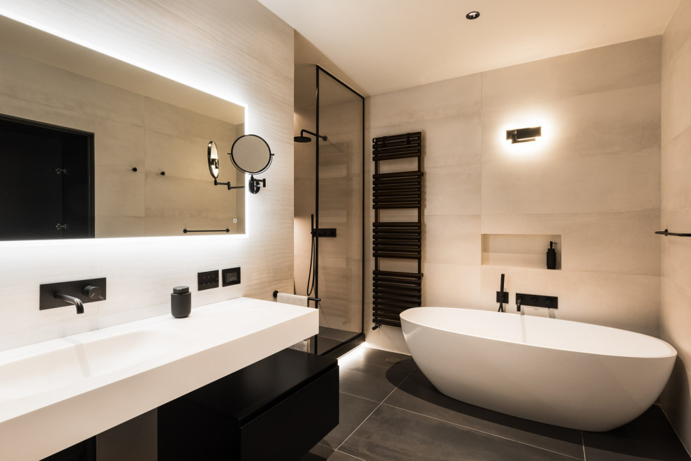 Design ideas for a large modern ensuite bathroom in Rome with a freestanding bath, an alcove shower, a two-piece toilet, beige tiles, porcelain tiles, beige walls, an integrated sink, black floors, a hinged door, white worktops, a single sink and a floating vanity unit.