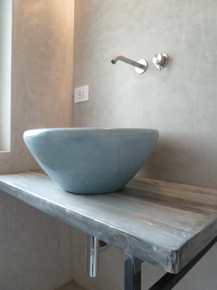 Réalisation d'une salle de bain urbaine avec un carrelage gris et un mur gris.