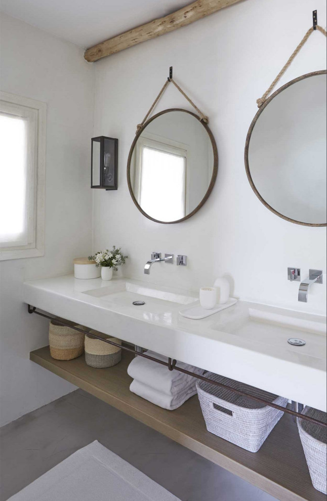 Foto di una stanza da bagno stile marino con pareti bianche, lavabo integrato, pavimento grigio e top bianco