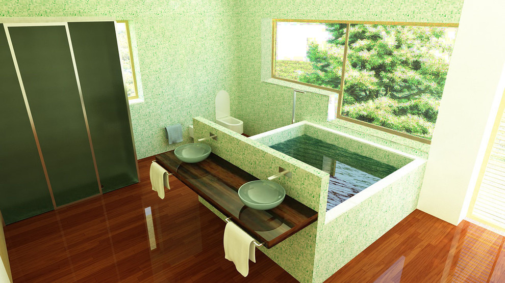 Idéer för ett mellanstort modernt en-suite badrum, med luckor med glaspanel, gröna skåp, en jacuzzi, en toalettstol med separat cisternkåpa, grön kakel, mosaik, gröna väggar, mellanmörkt trägolv, ett fristående handfat, träbänkskiva och brunt golv