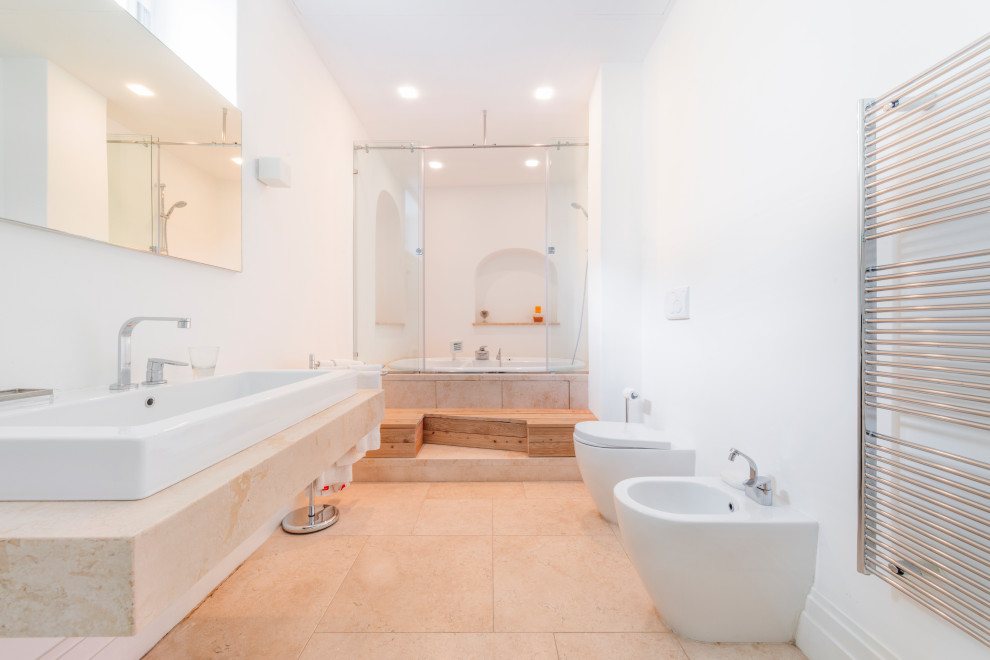 Inspiration for a large contemporary master porcelain tile, beige floor and single-sink bathroom remodel in Other with a hot tub, a two-piece toilet, white walls, a vessel sink, marble countertops, beige countertops and a floating vanity