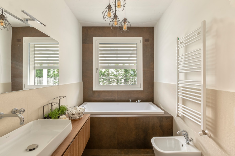 Example of a trendy brown floor and single-sink drop-in bathtub design in Other with flat-panel cabinets, medium tone wood cabinets, white walls, a vessel sink, wood countertops, brown countertops and a floating vanity
