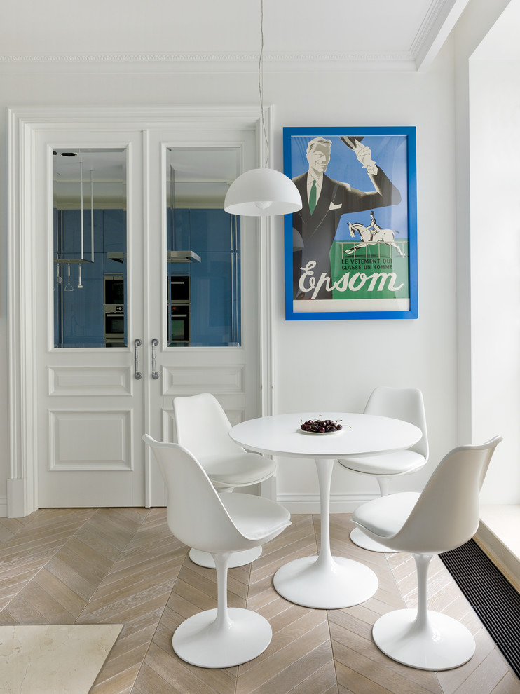 Contemporary dining room in Moscow with white walls and light hardwood flooring.