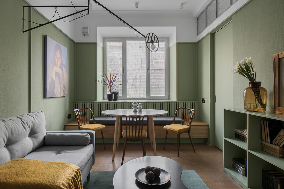 Идея дизайна: маленькая гостиная-столовая в стиле модернизм с зелеными стенами и коричневым полом для на участке и в саду