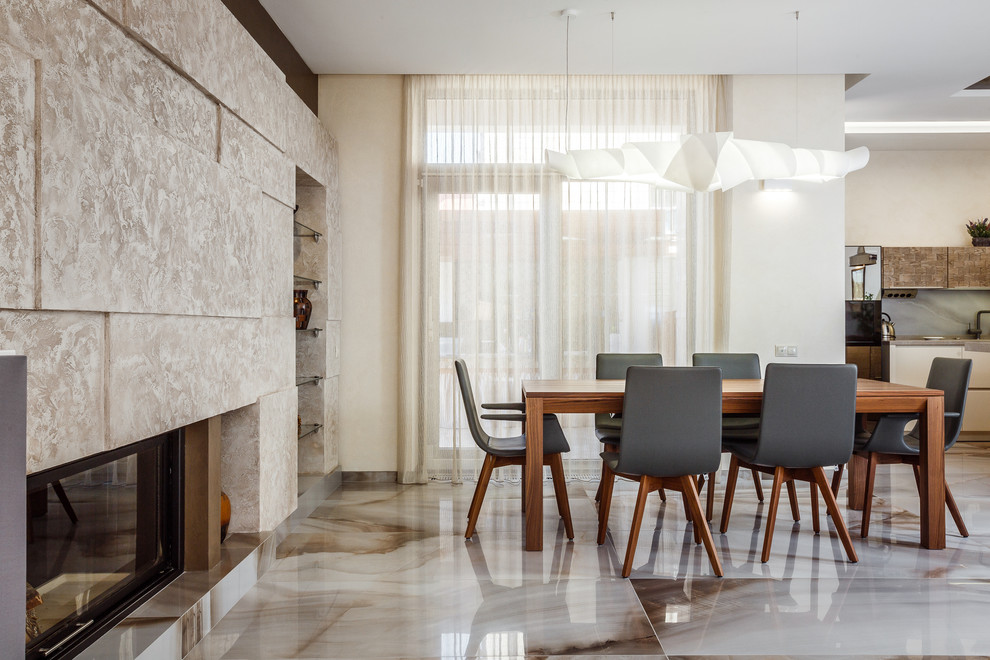 Idée de décoration pour une salle à manger ouverte sur le salon design de taille moyenne avec un mur blanc, un sol en carrelage de céramique et une cheminée standard.
