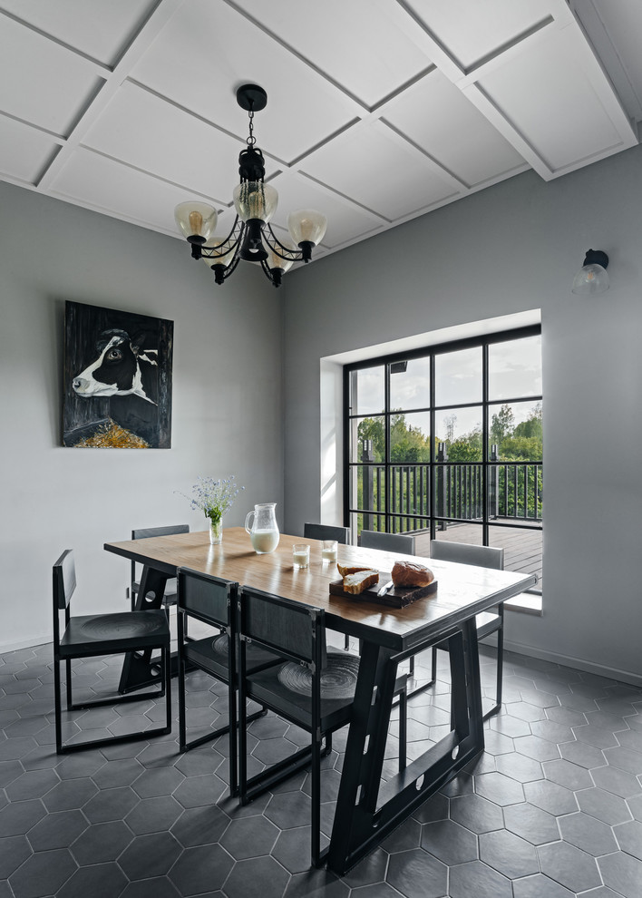 Photo of an urban open plan dining room in Other with grey walls.