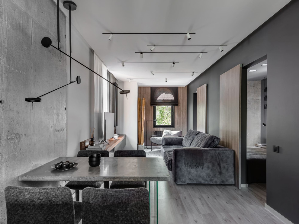 Idee per una sala da pranzo aperta verso il soggiorno design con pareti nere e pavimento grigio