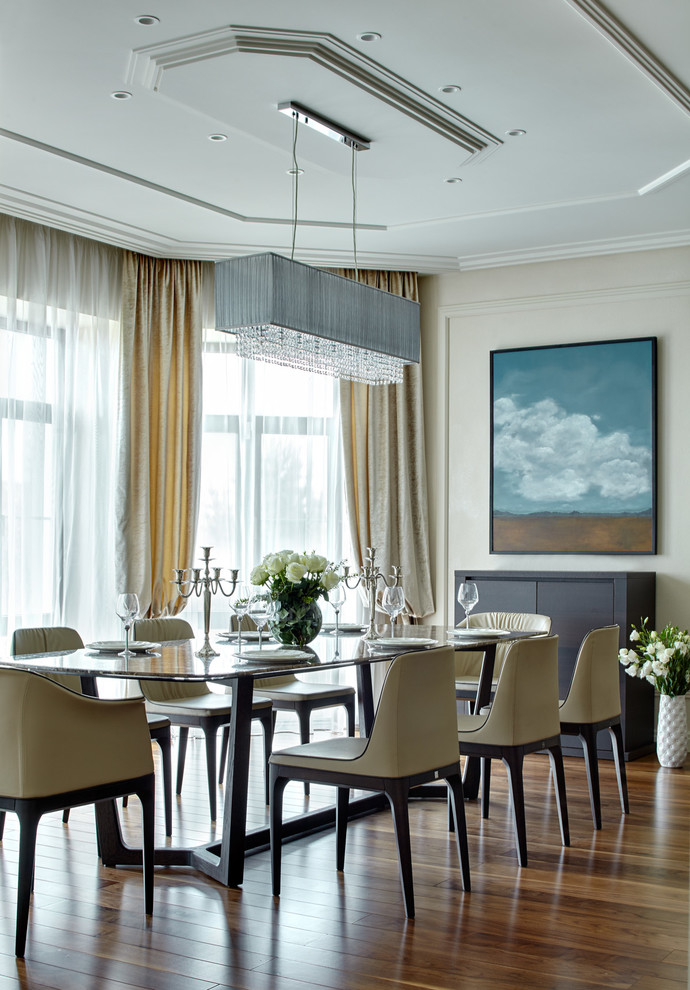 Immagine di una grande sala da pranzo aperta verso il soggiorno chic con pareti beige e pavimento in legno massello medio