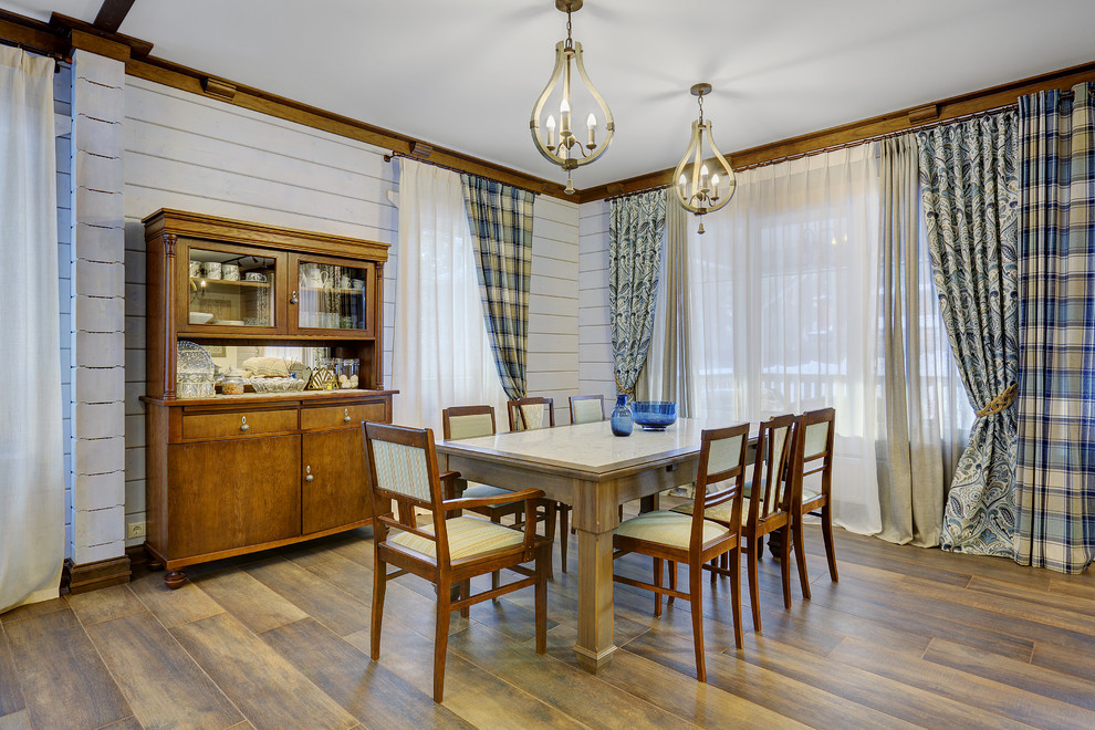 Exemple d'une salle à manger scandinave avec un mur blanc et un sol marron.