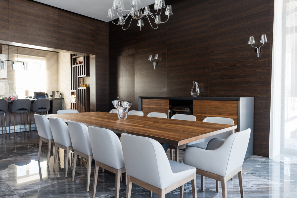 This is an example of a medium sized scandi open plan dining room in Moscow with brown walls, marble flooring and grey floors.