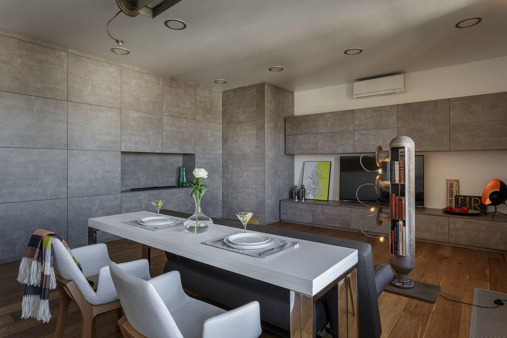 Идея дизайна: столовая среднего размера в современном стиле с серыми стенами, горизонтальным камином и коричневым полом