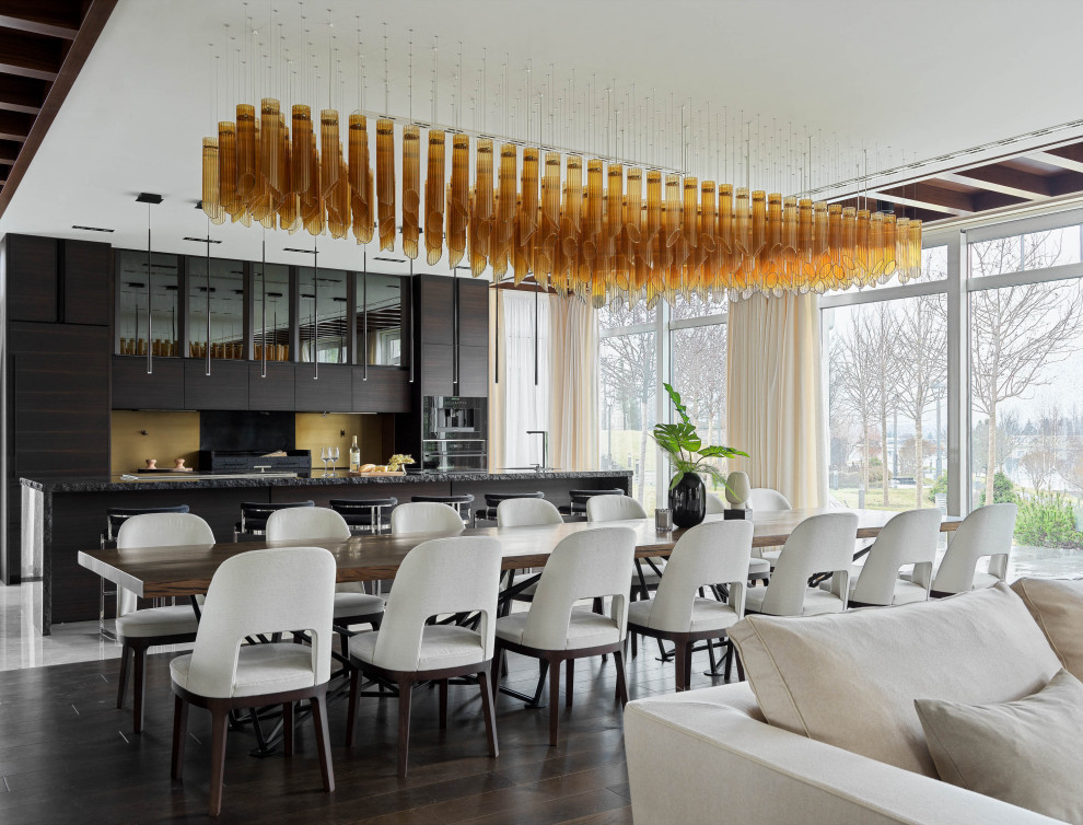 Cette image montre une salle à manger ouverte sur le salon design avec parquet foncé et un sol marron.