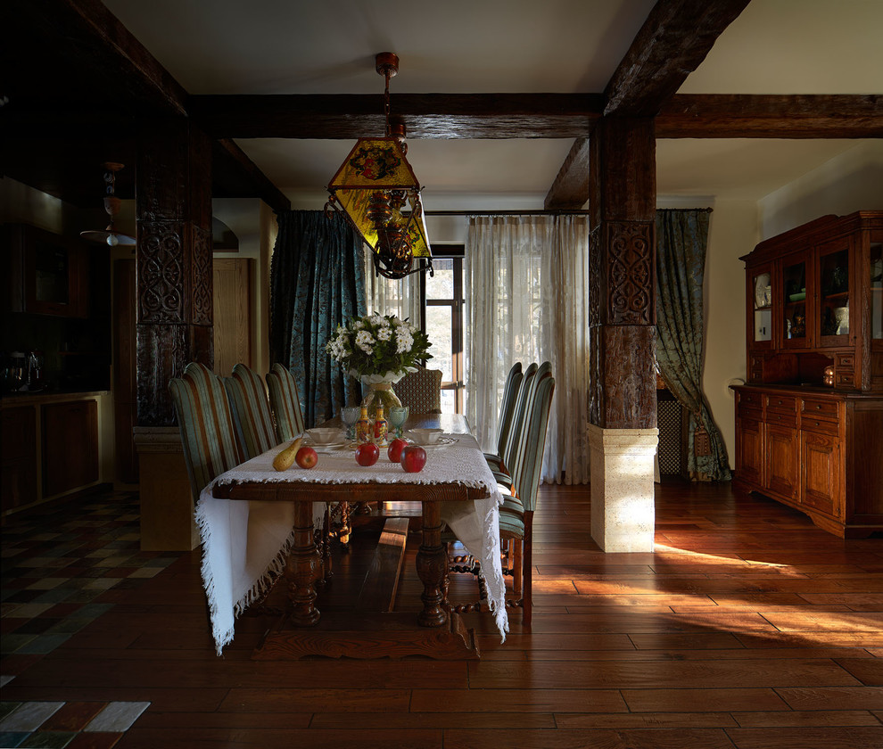 Photo of a country dining room in Other with dark hardwood flooring and brown floors.