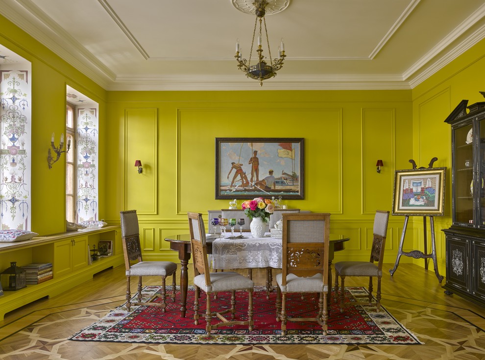 Design ideas for an eclectic dining room in Moscow with yellow walls and light hardwood flooring.