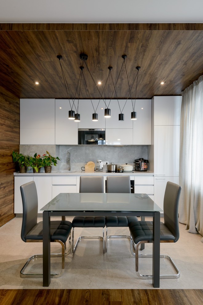 Esempio di una sala da pranzo aperta verso la cucina contemporanea con pavimento beige